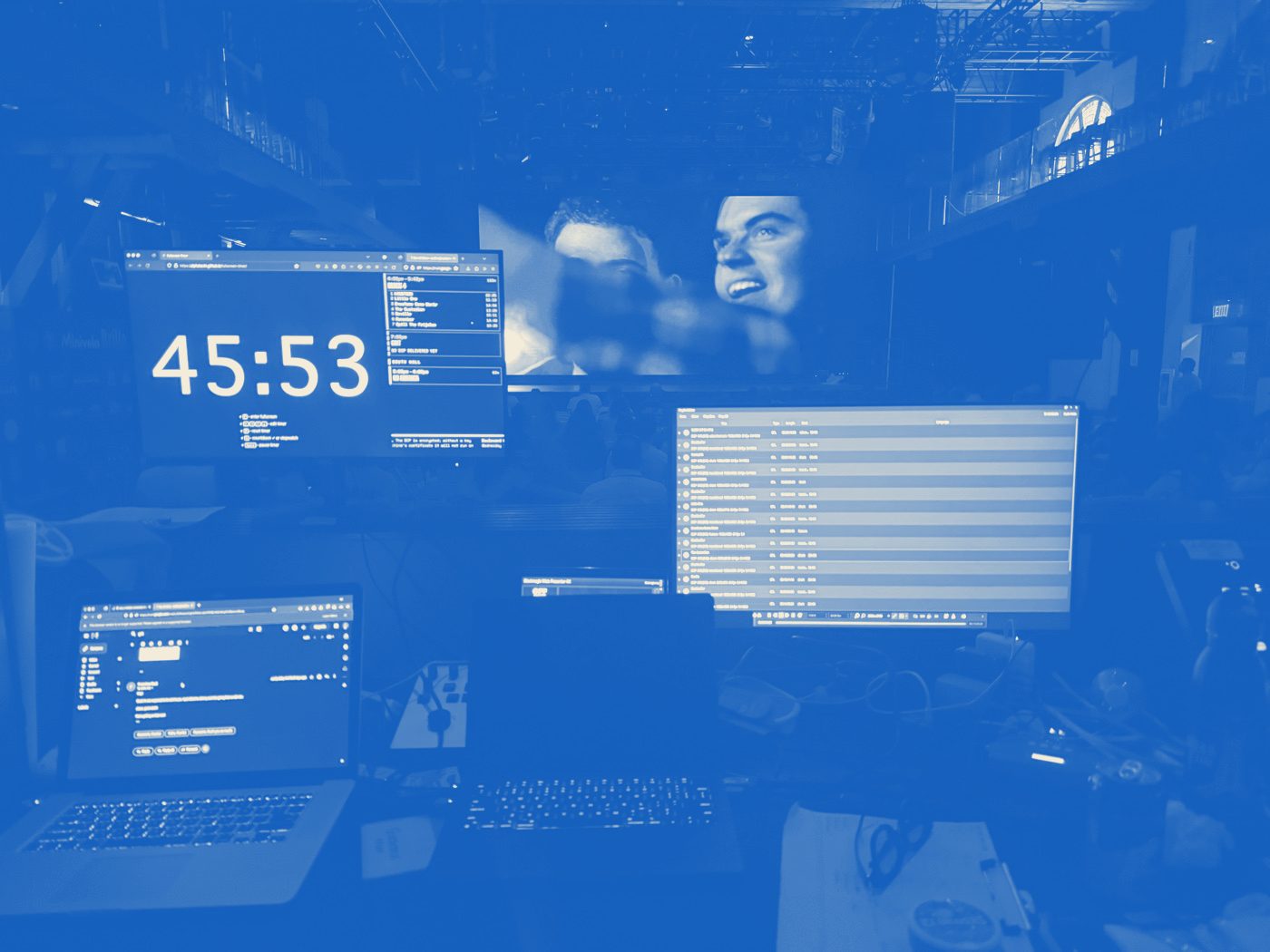 Front-of-house booth — run-of-show countdown timer and DCP playlist on the monitors